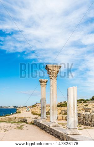 The column in the Ancient city Chersonese, on a bluesky background. Ruins of Basilica 1935 VI-X c. , Sevastopol, Crimea Russia. Free space for text.