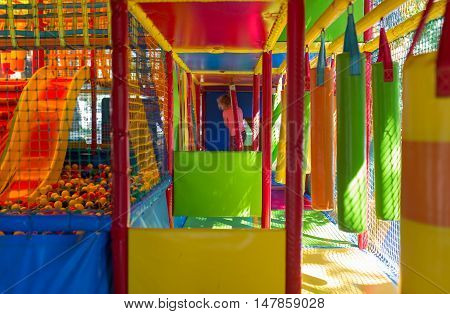 Cute little girl have fun at soft outdoor playground.