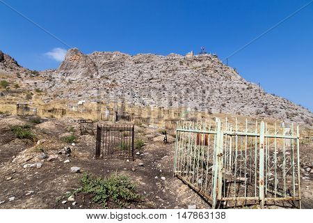 Osh, Kyrgyzstan - October 05, 2014: A traditional muslim cemetery at the foot of Solomons Hill