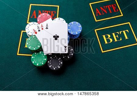 Poker chips on a poker table at the casino. Closeup. four aces, a winning combination. Chips winner