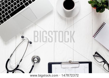 doctor workplace with a stethoscope and laptop - mock-up, space for taxt
