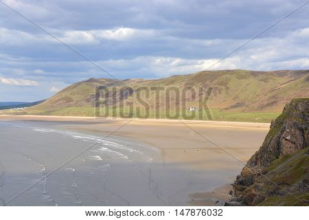 Rhossili Bay with distant people on beach. Gower Peninsular Wales UK
