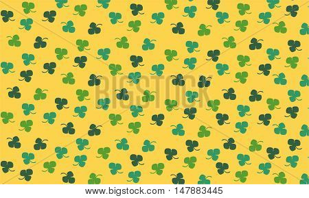 A green clover pattern on yellow background