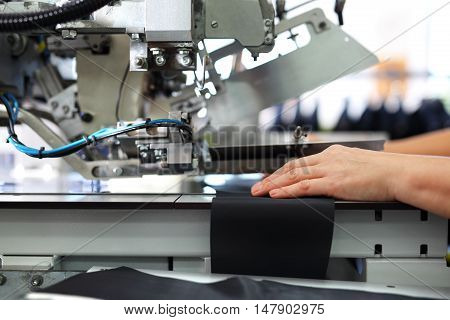 production plant, sewing clothes by seamstresses on the sewing machine
