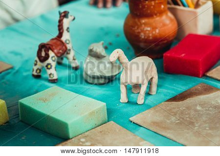 children's hands sculpts clay crafts pottery school