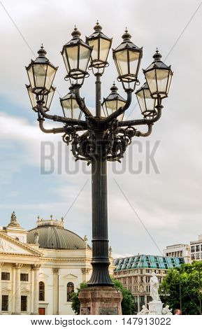 Old-fashioned city street lamp in the nigt. Gendarmenmarkt in Berlin, Germany