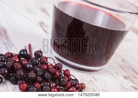 Bunch Of Fresh Elderberry With Juice On Old Wooden Background, Healthy Nutrition