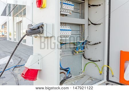 Electrical cabinet with connectors is providing electrical energy to construction site.
