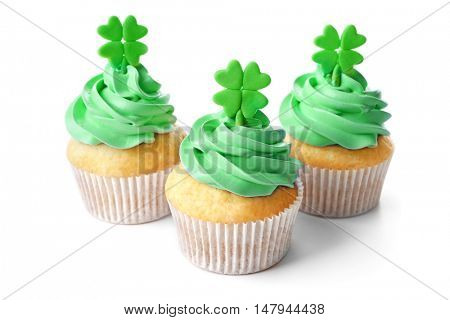 Tasty cupcakes with clover, isolated on white. Saint Patrics Day concept