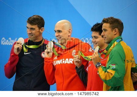 RIO DE JANEIRO, BRAZIL - AUGUST 12, 2016: Michael Phelps USA (L), Laszlo Cseh HUN,Joseph Schooling SGP and Chad le Clos RSA during medal ceremony after Men's 100m butterfly of the Rio 2016 Olympics