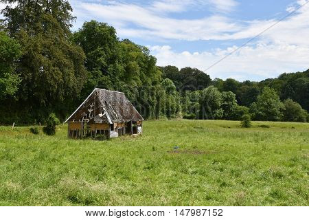cailly France - june 23 2016 : an old barn in a meadow