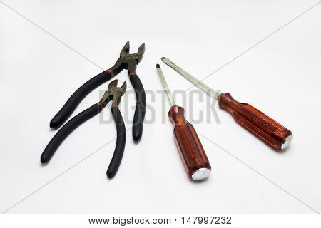 Pliers and screwdriver on a white background.