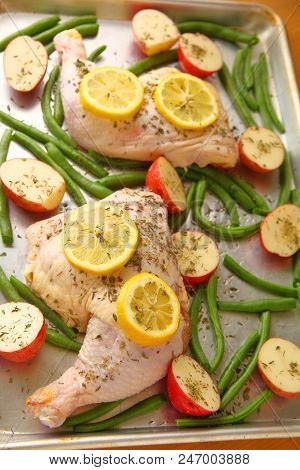 Overhead View Of Chicken Sheet Pan Meal With Potatoes, Lemon And Green Beans