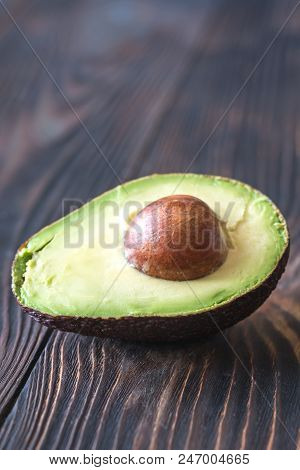 Halved Avocado On The Wooden Background