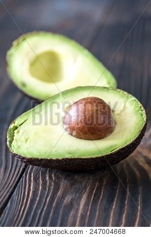 Halved Avocado On The Wooden Background