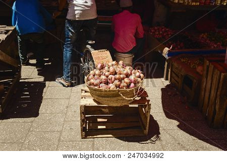 Wicker Basket Full Of Onions In The African Market