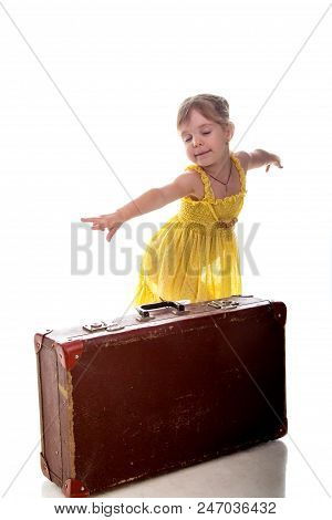 The Young Traveler Girl With A Suitcase. Isolated Over White Background