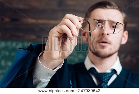 Let Me See. Teacher Formal Wear And Glasses Looks Concentrated, Chalkboard Background. Chalkboard Fu