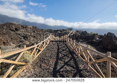 Wooden Pathway Along The Coast With Mountaincliff And Clouds, El Golfo, Frontera, El Hierro, Canary 