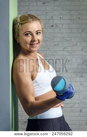 Nice Athlete Girl Is Doing Exercises With A Barbell