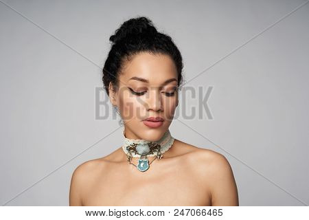 Beauty Closeup Portrait Of Beautiful Mixed Race Woman Wearing Chocker Posing, Isolated On Gray Backg