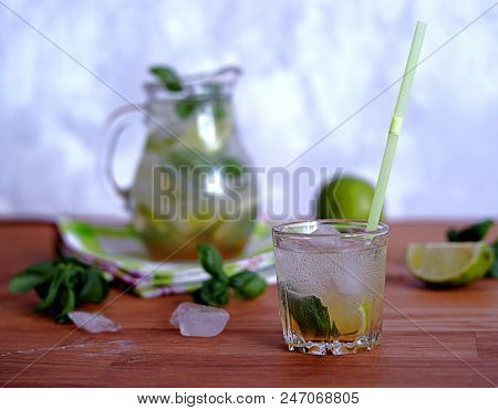Cold Summer Drink, Lemonade With Lime And Basil On The Basis Of Sparkling Water And Sugar Syrup In A