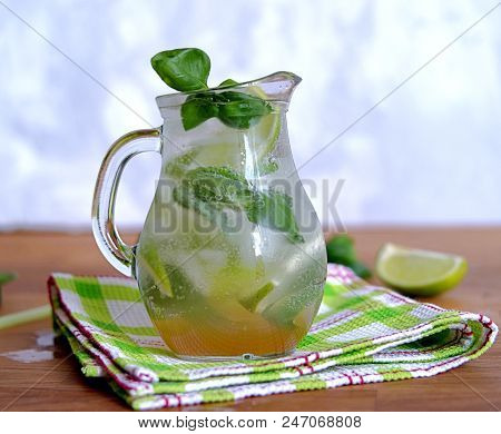 Cold Summer Drink, Lemonade With Lime And Basil On The Basis Of Sparkling Water And Sugar Syrup In A