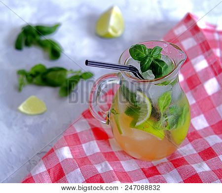 Cold Summer Drink, Lemonade With Lime And Basil On The Basis Of Sparkling Water And Sugar Syrup In A