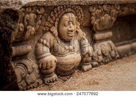 Sri Lanka, Anuradhapura. Mythological Character On A Stone Wall Of A Buddhist Temple Close-up.