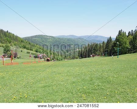Picturesque Landscapes Of Grassy Field And Forest At Beskid Mountains Range In European Salmopol Pas
