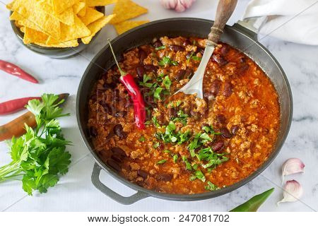 Mexican And American Food Chili Con Carne Served With Nachos, Pepper And Herbs. Selective Focus.