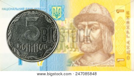 5 Ukrainian Kopiyka Coin Against 1 Ukrainian Hryvnia Banknote