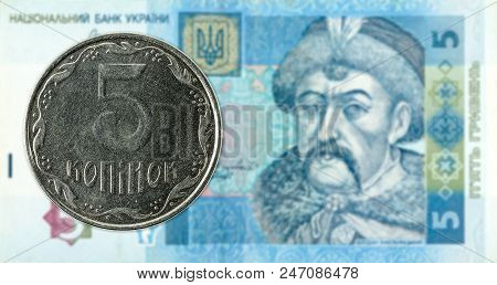 5 Ukrainian Kopiyka Coin Against 5 Ukrainian Hryvnia Banknote