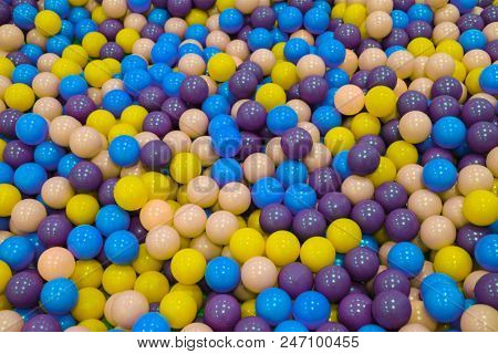 Colorful Child Balls. Multi-colored Plastic Balls. A Children's Playroom. Background Texture Of Mult