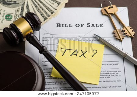 To Pay Real Estate Tax Concepty. Bill Of Sale, Money, Keys And Sticker With The Question Tax On Tabl