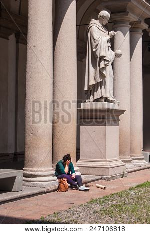 Girl Sitting Near The Marble Statue Of The Statue Of The Italian Mathematician Inventor Of The Axono