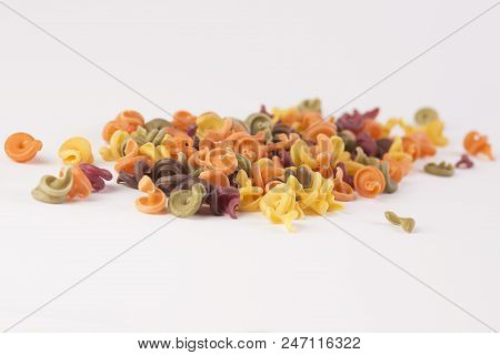 Raznotsetnaya Paste In The Form Of Shells Background White. Overall Plan