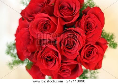 Close Up On A Bouquet Of Red Roses From A Bride