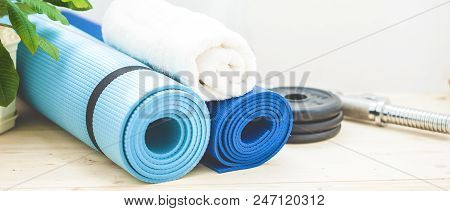 Set For Sports, A Yoga Mat, A Towel, A Dumbbell And A Bottle Of Water On A Light Background. The Con