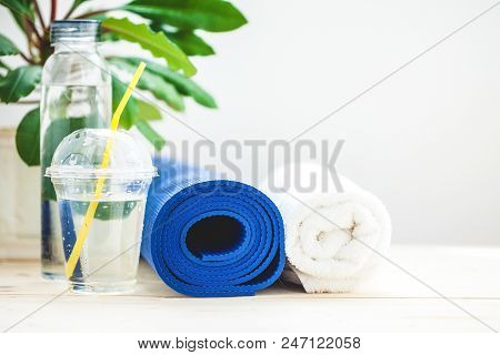 Set For Sports, Blue Yoga Mat Towel And A Bottle Of Water On A Light Background The Concept Of A Hea