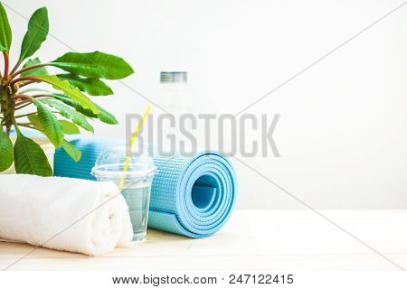 Set For Sports. Yoga Mat Towel And A Bottle Of Water On A Light Background The Concept Of A Healthy 