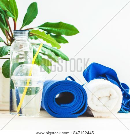 Set For Sports, Blue Yoga Mat Towel And A Bottle Of Water On A Light Background The Concept Of A Hea