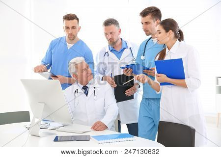 Group Of Doctors Attending Meeting In Clinic. Cardiology Conference