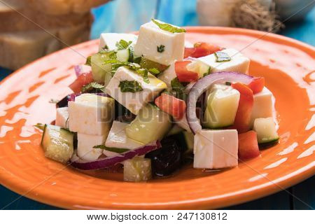 Greek salad with feta cheese cubes and fresk vegetables
