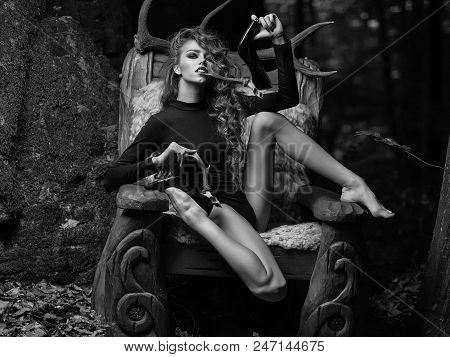 Caucasian Female Fashion Model Posing. One Beautiful Young Flexible Sensual Girl With Long Curly Hai