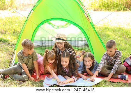Little Children With Map Near Tent Outdoors. Summer Camp