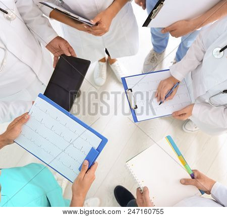 Group Of Doctors Attending Meeting In Clinic. Cardiology Conference