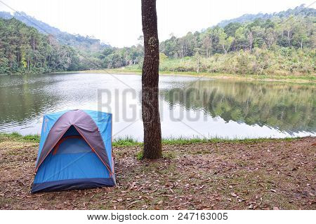 Camping In Forest And Riverside,camping Is An Outdoor Activity Involving Overnight Stays Away From H