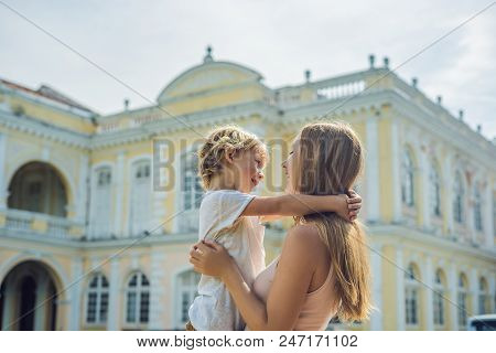 Mom And Son On Background Of Old Town Hall In George Town In Penang, Malaysia. The Foundation Stone 