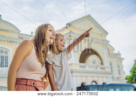 Mom And Son On Background Of Old Town Hall In George Town In Penang, Malaysia. The Foundation Stone 